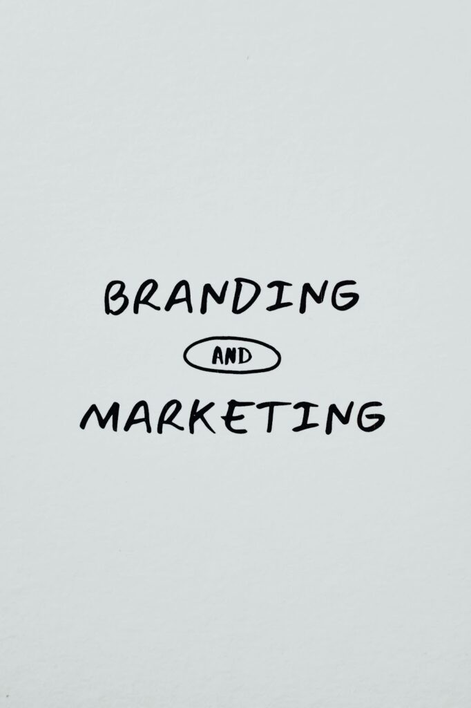 A grey paper with the words "Branding" and "Marketing" written on it.