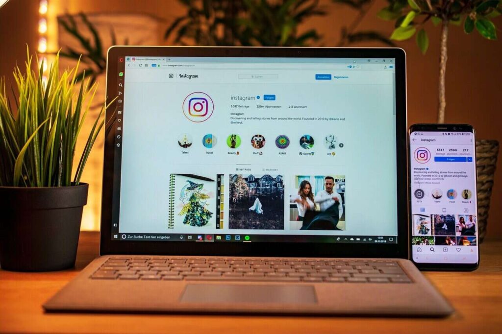 A laptop and smartphone displaying the Instagram website on their screens